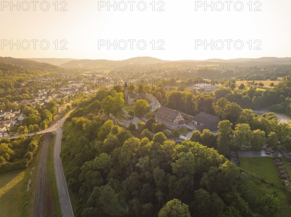 A village on a hill surrounded by forest and half-timbered houses at dusk, event and wedding location Lorch Monastery, Lorch, Germany