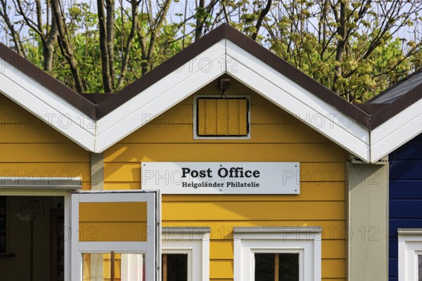 Yellow lobster shack, sign with inscription post office, Helgoland philately, facade detail, Museum Helgoland, Helgoland, Schleswig-Holstein, Germany