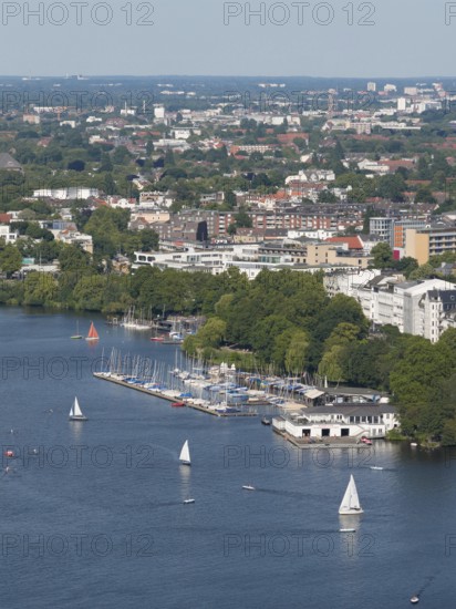 Aerial view of the Outer Alster with sailing ships and view of the rowing club Allemania from 1866 surrounded by green trees and urban buildings, Hamburg, Germany
