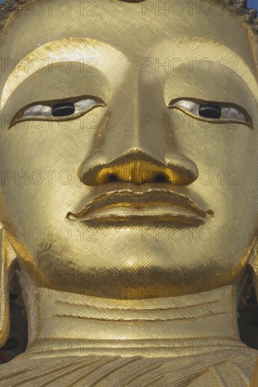 Face of a 32 metre high standing Buddha decorated with glass mosaics and 24-carat gold, Luang Pho To or Phrasiariyametri, Wat Intharawihan, Bangkok, Thailand