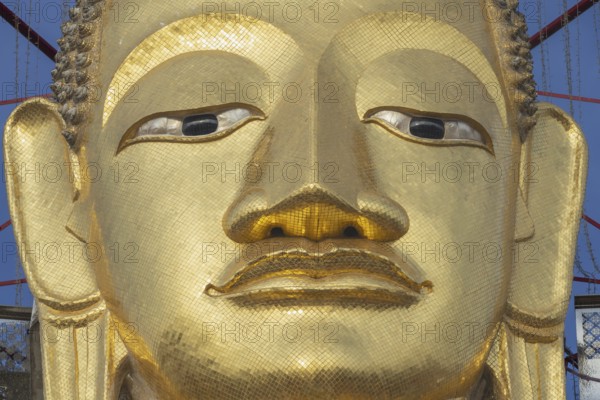 Face of a 32 metre high standing Buddha decorated with glass mosaics and 24-carat gold, Luang Pho To or Phrasiariyametri, Wat Intharawihan, Bangkok, Thailand