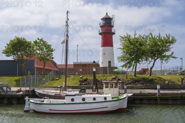 Sailing ship at the harbour, behind lighthouse, Büsum, North Sea, Schleswig-Holstein, Germany