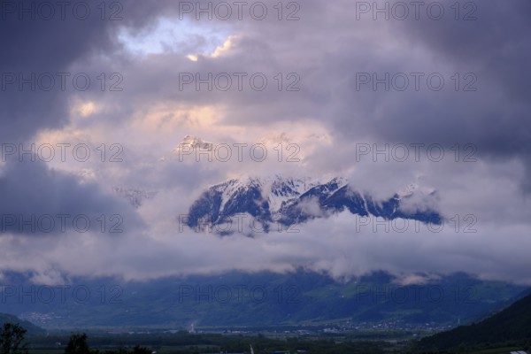 Dark clouds in front of the snow-covered Ortler, Malles, Val Venosta, South Tyrol, Italy