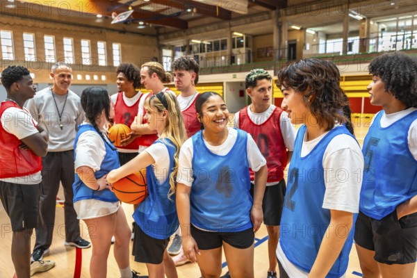 High school basketball team listening to their coach's instructions during a training session in the gym