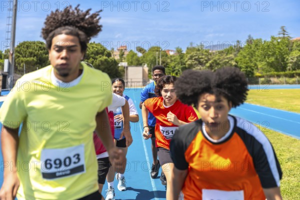 Diverse athletes competing fiercely on a vibrant blue track, pushing their limits and striving for victory in an exhilarating race