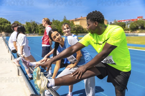 Runners stretching their legs on a sunny running track, preparing for an upcoming race and embracing the energy of competition