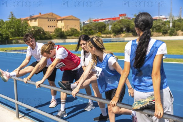 Runners stretching their legs on a vibrant blue track, preparing for a race while enjoying the summer sun and outdoor atmosphere