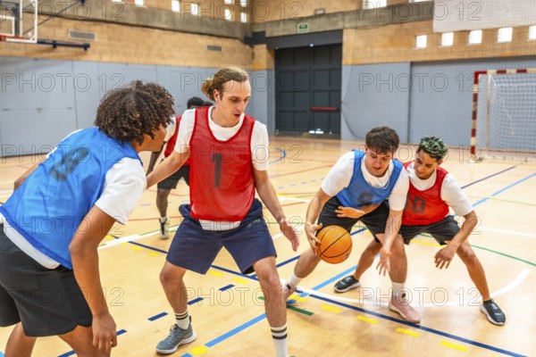 Young basketball players practicing in a gym, focusing on defense and attack strategies during a dynamic training session