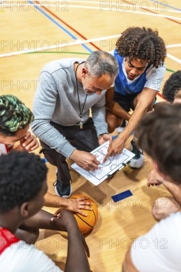 Basketball coach discussing game strategy with team players during a timeout on the court, fostering teamwork and tactical understanding