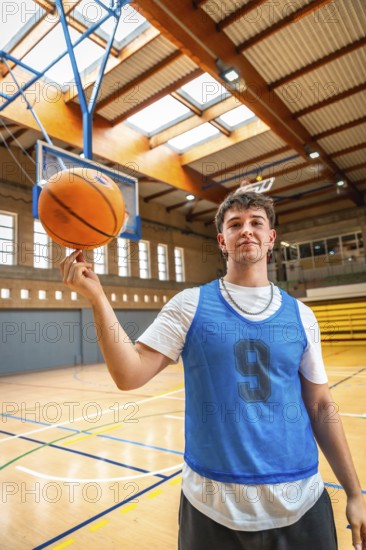 Young basketball player spinning a ball on his finger in a gym, showcasing his skills and passion for the sport
