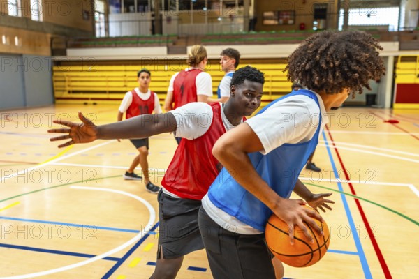 Two basketball players competing for the ball during a training match, showing sportsmanship and athleticism
