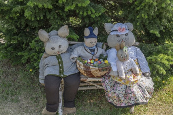Rabbit family on a bench, Easter decoration in a village in Upper Franconia, Bavaria, Germany