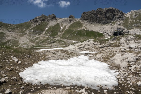 Remnant of snow and view of the Hintersteiner via ferrata, Nebelhorn, Oberstdorf, Allgäu Alps, Allgäu, Bavaria, Germany
