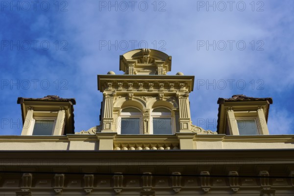 Decorative façade of a historic building with windows and baroque details under a blue sky, Freiburg im Breisgau, Black Forest, Baden-Württemberg, Germany