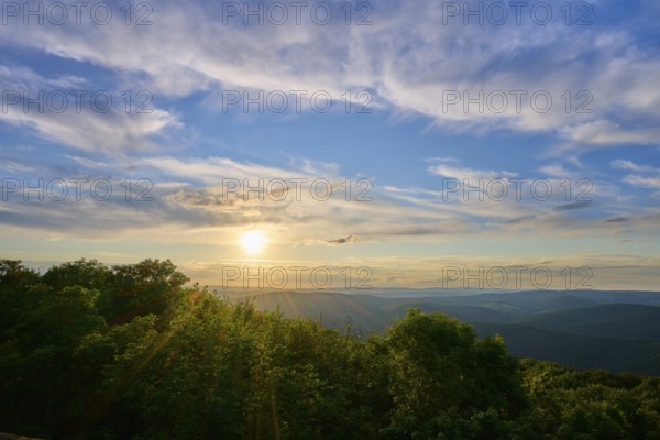 Sunset over wooded landscape with picturesque clouds, Katzenbuckel, Waldbrunn, Neckar-Odenwald-Kreis, Odenwald, Baden-Württemberg, Germany