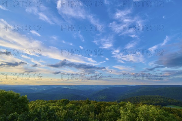 Fresh evening sky sunset over lush forest, clouds passing by, Katzenbuckel, Waldbrunn, Neckar-Odenwald-Kreis, Odenwald, Baden-Württemberg, Germany