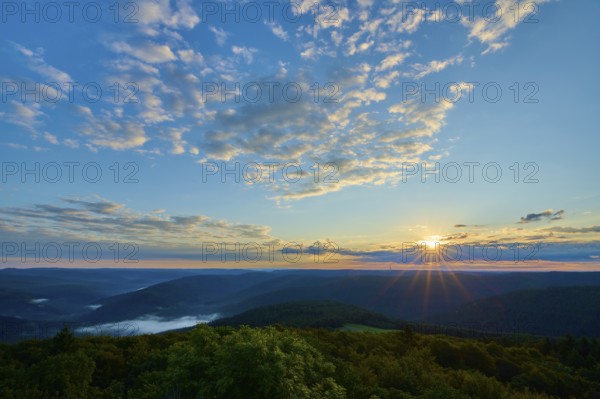 Sunrise over wooded hills, sky with light clouds and warm morning light, Katzenbuckel, Waldbrunn, Neckar-Odenwald-Kreis, Odenwald, Baden-Württemberg, Germany