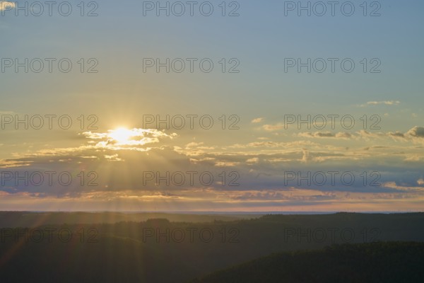Sunrise over a calm landscape with clouds and rays of light, Katzenbuckel, Waldbrunn, Neckar-Odenwald-Kreis, Odenwald, Baden-Württemberg, Germany