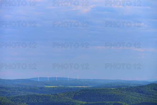Hilly landscape with clouds, wind turbines on the horizon under a blue sky, Katzenbuckel, Waldbrunn, Neckar-Odenwald-Kreis, Odenwald, Baden-Württemberg, Germany