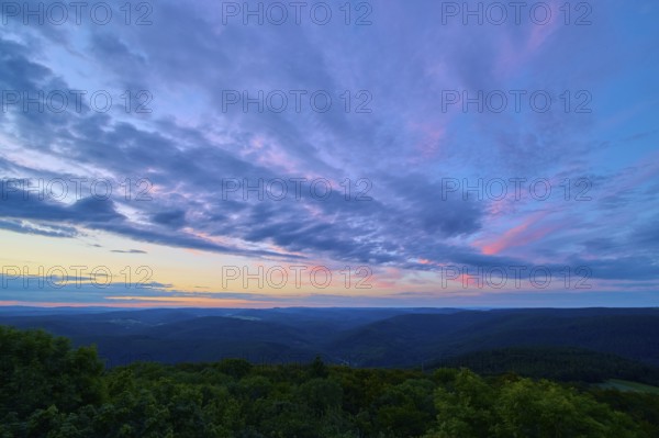 Purple and pink clouds fill the night sky over a forest landscape, twilight, Katzenbuckel, Waldbrunn, Neckar-Odenwald-Kreis, Odenwald, Baden-Württemberg, Germany