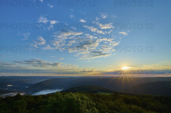 Morning sun over a vast forest landscape, clear sky with some clouds, Katzenbuckel, Waldbrunn, Neckar-Odenwald-Kreis, Odenwald, Baden-Württemberg, Germany