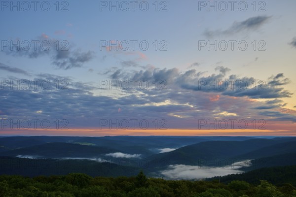 Wide mountain landscape at sunrise, sky covered by clouds in soft colours, Katzenbuckel, Waldbrunn, Neckar-Odenwald-Kreis, Odenwald, Baden-Württemberg, Germany