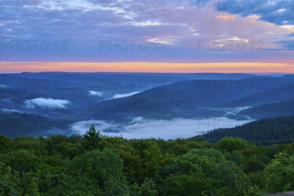 Hilly landscape at dusk, fog in the valleys, orange-blue sky, Katzenbuckel, Waldbrunn, Neckar-Odenwald-Kreis, Odenwald, Baden-Württemberg, Germany