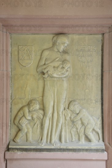 Relief in the inner courtyard of the town hall with inscription Give us today our daily bread, Matthew 6.11, Bible quotation, Lord's Prayer, prayer, saying, infant, poor, carry, care, protect, protect, care, give, grain, nutrition, symbol, confidence, future, security, town hall, Dessau, Dessau-Roßlau, Saxony-Anhalt, Germany