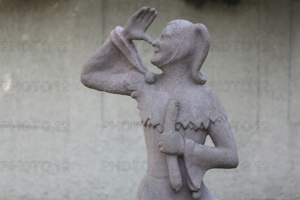 Sculpture of Till Eulenspiegel with gesture, thumb on nose, arm, high, up, hand, Bernburg, Saxony-Anhalt, Germany