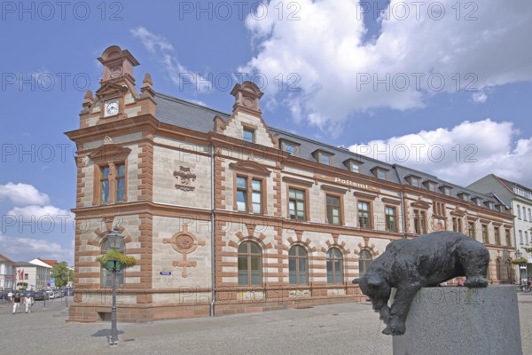 Historic post office and post office fountain with bear figure catching fish, sculpture, fountain, Bernburg, Saxony-Anhalt, Germany