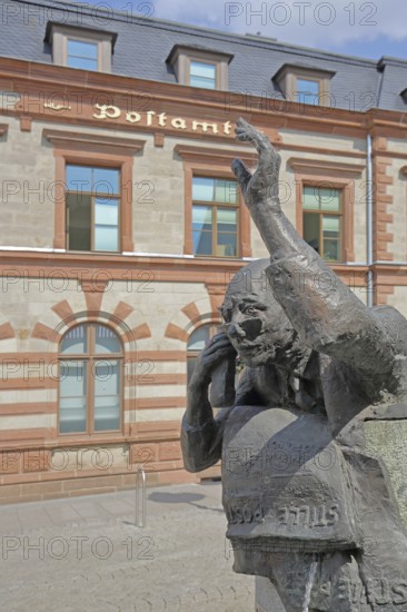 Postal fountain with sculpture symbolising silent mail, inscription, telephoning, gesture, arm, high, above, post office, Bernburg, Saxony-Anhalt, Germany