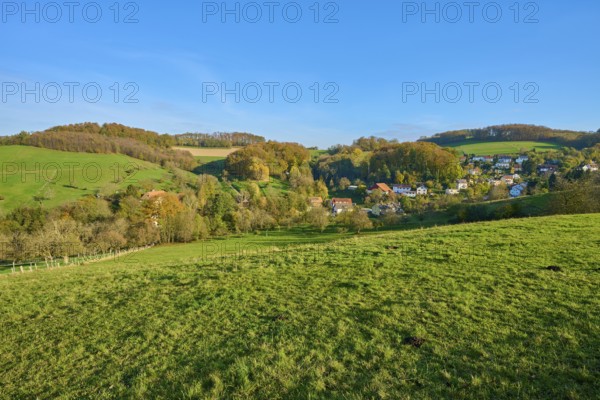 Small village embedded in green hills and trees, creating a harmonious landscape, Vöckelsbach, Mörlenbach, Bergstrasse district, Odenwald, Hesse, Germany