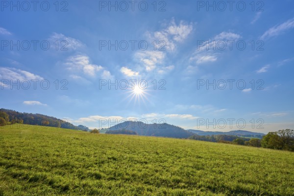 Sunny hilly landscape with a wide view of blue sky and greenery, Vöckelsbach, Mörlenbach, Bergstrasse district, Odenwald, Hesse, Germany