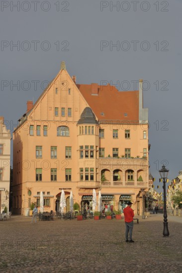 Historic building built in 1908 on the market square, mood lighting, pedestrian, Luther city Wittenberg, Fläming, Saxony-Anhalt, Germany