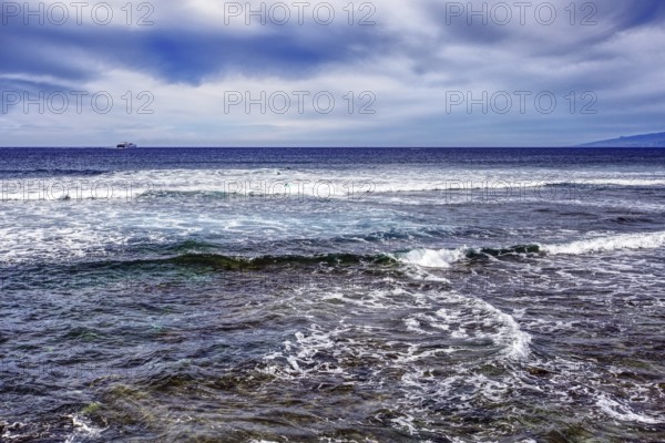 Waves breaking in the sea under a cloudy sky, Tenerife, Canary Islands