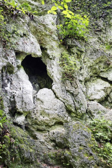 Picturesque view of a rock face with a large hole, like a cave entrance, Bad Urach