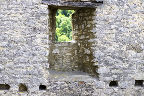Stone window of the Reußenstein castle ruins with a view of the surrounding nature, Neidlingen