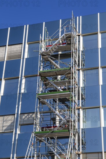 Steel scaffolding on the large glass façade of an office building