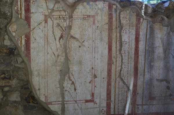 Weathered fresco with red decorative elements on ancient wall, Archaeological site, House of Beluga (sturgeon), Postman, Western Excavation, Kos Town, Kos, Dodecanese, Greek Islands, Greece