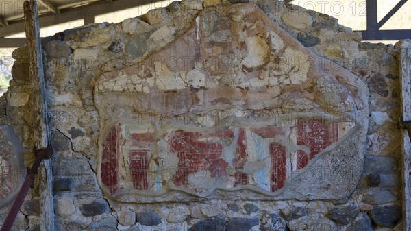 Ancient worn wall remnant with red drawings on stone wall, Archaeological site, House of Europe, Letter carrier, Western excavation, Kos town, Kos, Dodecanese, Greek Islands, Greece