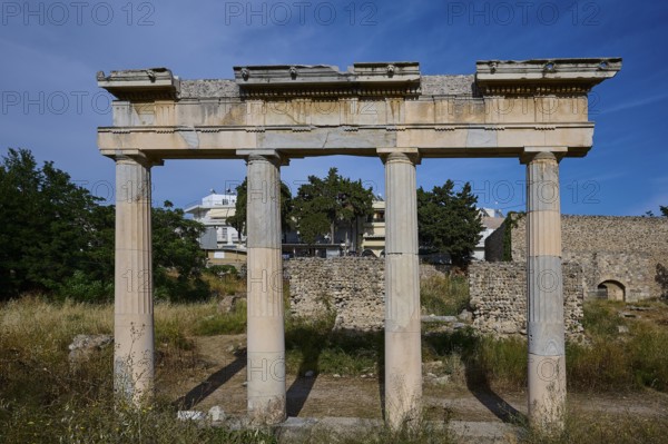 Ruins with three standing ancient columns and building remains in the background, Archaeological site, Xysto Columned Hall, Gymnasio, Western Excavation, Kos Town, Kos, Dodecanese, Greek Islands, Greece