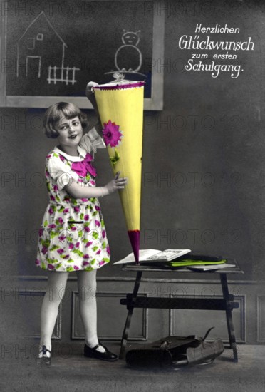 First day at school, 1930, Girl with colourful school bag in front of a blackboard, Historical photo