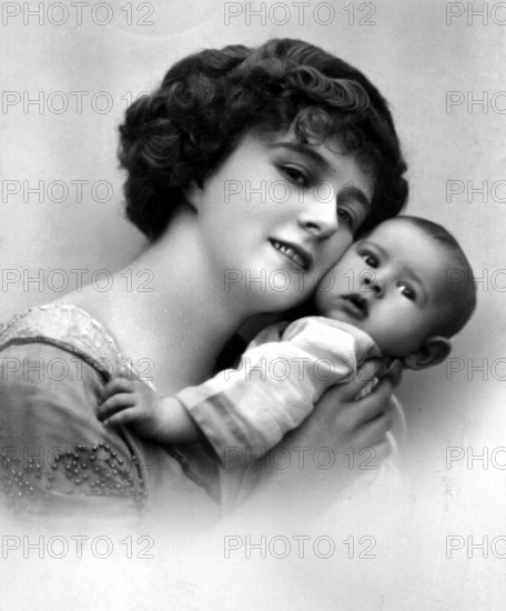 Mother with baby, close-up of a woman lovingly embracing her baby, historical photo