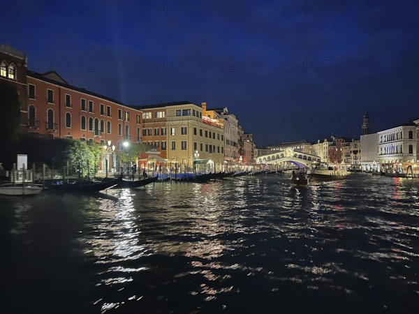 Gondolas on the Grand Canal, Rialto Bridge in the background, night shot, lagoon city of Venice, Veneto, Italy