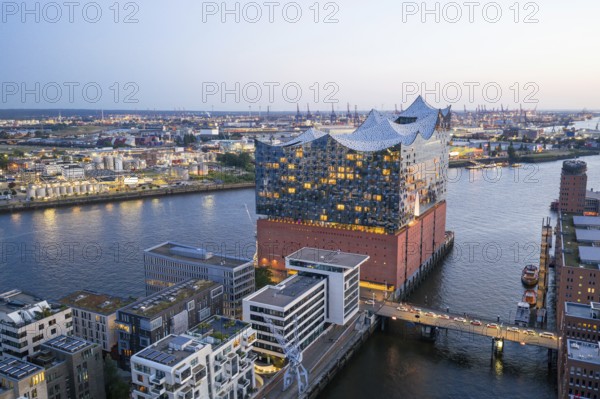 Aerial view of the Elbphilharmonie at blue hour with harbour and Elbe in the background, Hamburg, Germany