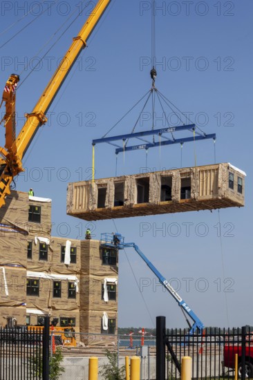 Detroit, Michigan - Workers use modular construction methods to build apartments for low to moderate income households. Each module is put together off site by Ginosko Modular