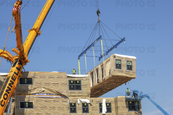 Detroit, Michigan - Workers use modular construction methods to build apartments for low to moderate income households. Each module is put together off site by Ginosko Modular