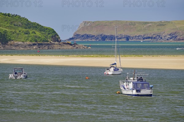 Boats on a river with green hills and rocky coast in the background, tides, Camel Trail, Padstow, Cornwall, Cornwall, England, United Kingdom