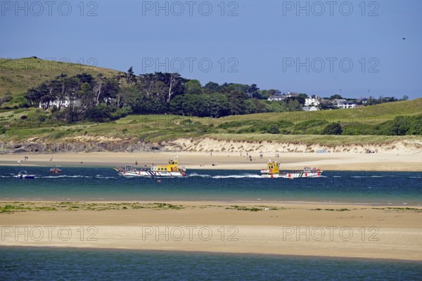 Two boats on the sea with green hills and a clear sky in the background, Padstow, Cornwall, Cornwall, England, United Kingdom