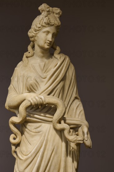 Marble statue of a woman with curly hair holding a snake, presented in classical style, Goddess Hygieia, Goddess of Health, aArchaeological Museum, Kos Town, Kos, Dodecanese, Greek Islands, Greece